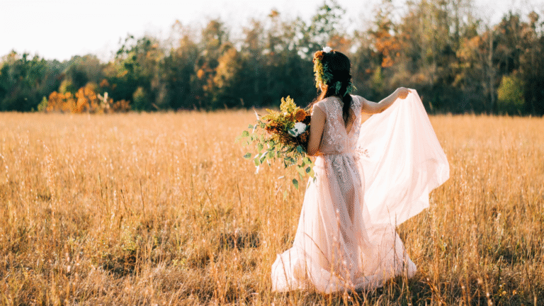 Rent Portable Toilets Fall Wedding in North Carolina Wilmington Weddings North Carolina Weddings Outdoor Weddings Bride walking in field in fall holding bouquet