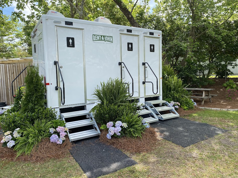 Rent-A-John portable restroom trailer with landscaping for a wedding reception.